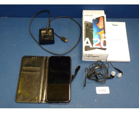 A Samsung Galaxy A20e mobile phone, in box together with case, charger, earphones and manual.