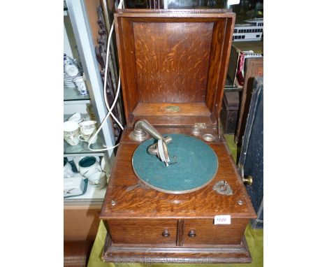 An 1930's Oak cased record player, 11 3/4" tall x 16" wide x 17 1/4" deep.