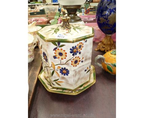 An octagonal cheese dish decorated with yellow and blue flowers with gold finial, large crack through base, 13" high x 10" di