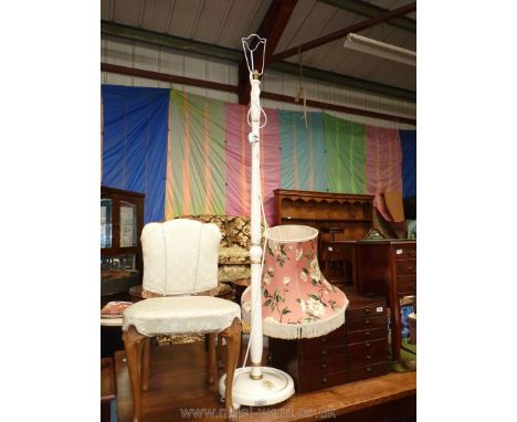 A turned wood cream painted and floral detail Standard Lamp with a pink ground floral decorated fringed shade.