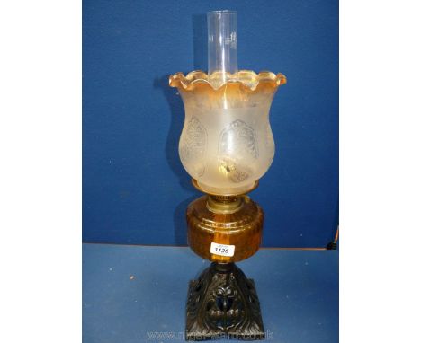 A Victorian oil Lamp on a triangular metal base, smoky glass central reservoir and a frosted glass ruffle topped shade, 22" t