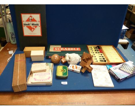 A quantity of games including 3D wooden slot together puzzle, Scrabble, Chess, Dominoes, playing cards etc.