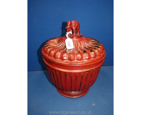 A Burmese red lacquer (hsun ok) offering bowl of fluted form, the finial carved as an elephant, 12'' tall x 10'' diameter (sm