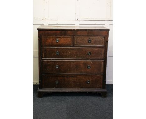 A 19th century cross banded oak chest of two short over three drawers with ring handles, with quarter column uprights, on scr
