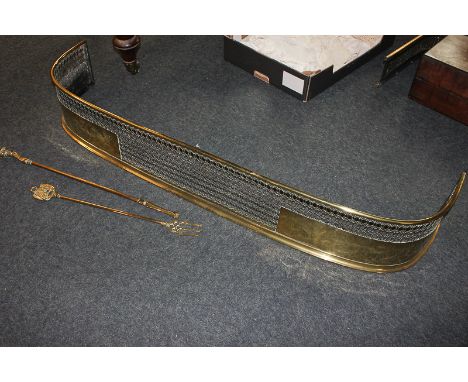 A brass fire fender with pierced design, 120cm wide, together with a toasting fork and poker