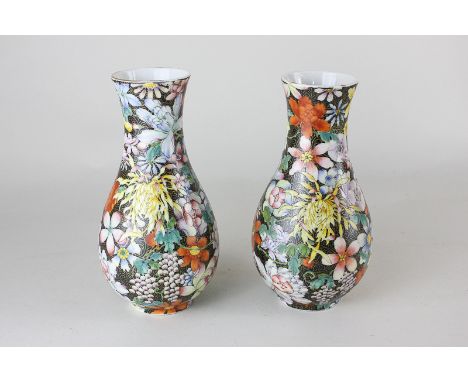 A pair of Chinese porcelain vases with bright enamel flowers on black ground, seal mark to base, 16cm high