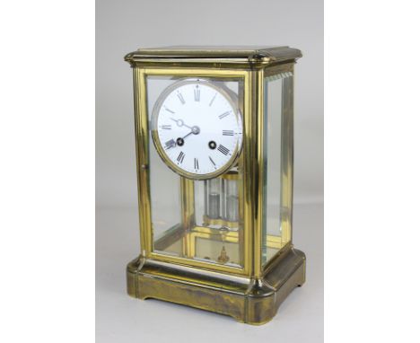 A gilt metal four-glass mantel clock with circular 4 inch white enamel dial and movement with mercury pendulum, striking on a