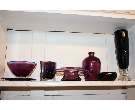 A collection of seven amethyst glass items including a conical bowl, 14cm, tall tapering vase, three other various vases and 