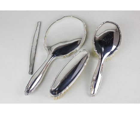 A German 800 silver four piece dressing table set of two brushes, hand mirror and comb cover