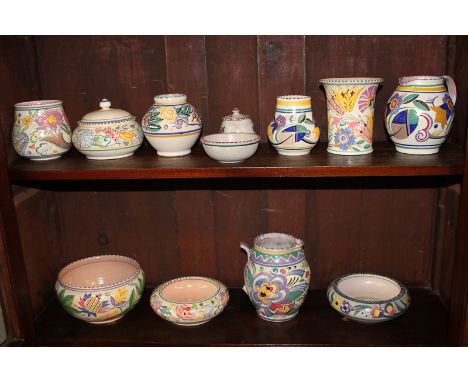 A collection of Poole and similar pottery, including jugs, vases and bowls, decorated in bright floral designs (a/f)
