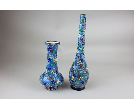 Two small French Longwy pottery vases with floral decoration on blue ground, a specimen vase with long stem, sticker and mark