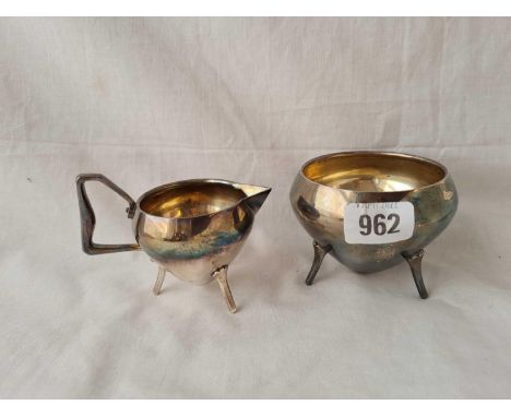 A Christopher dresser sugar basin and cream jug of scuttle form with registered number 2272 