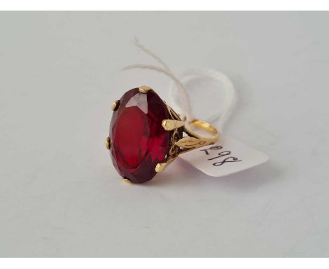 A large oval red stone dress ring 9ct - 7.3 g.