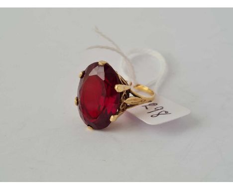 A large oval red stone dress ring 9ct - 7.3 g.