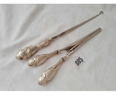 An angel decorated pair of glove stretchers and a button hook 