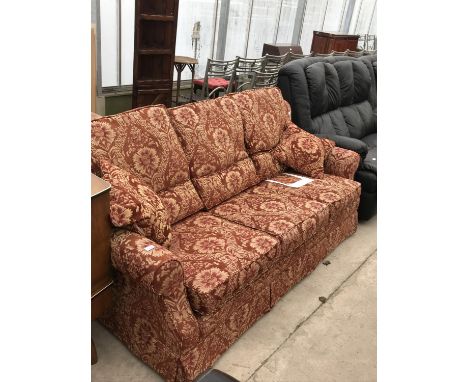 A WADE PATTERNED FABRIC THREE SEATER SOFA 