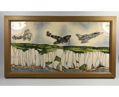 A MOORCROFT POTTERY 'FLYING COLOURS' R.A.F PATTERN PLAQUE IN LIGHT WOODEN SURROUND, 26 X 47CM 