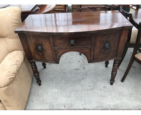 A SMALL BOW FRONT MAHOGANY SIDEBOARD WITH THREE DRAWERS 