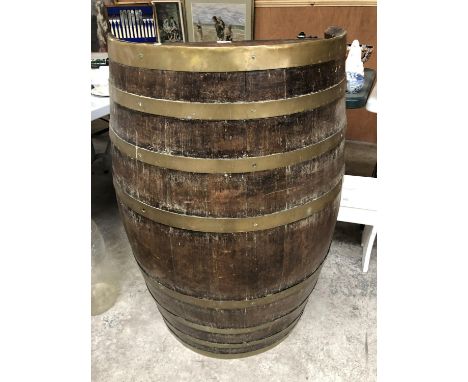 A VINTAGE OAK AND BRASS BOUND HALF BARREL WITH SHELVING TO ONE SIDE 