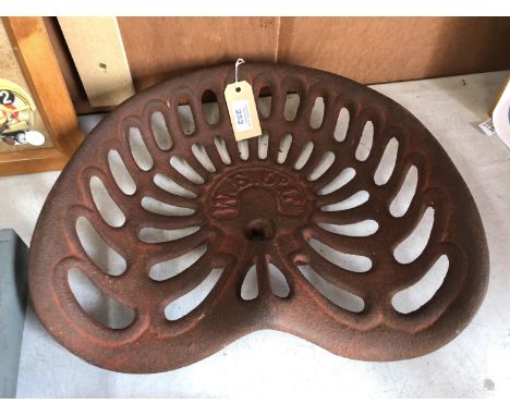 A VINTAGE CAST METAL 'W.E CO LTD' TRACTOR / IMPLEMENT SEAT 