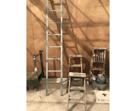 A TWO STEP FOLDING STEP LADDER, A THREE STEP FRAME LADDER AND A NINE STEP METAL LADDER WITH HOOKS 