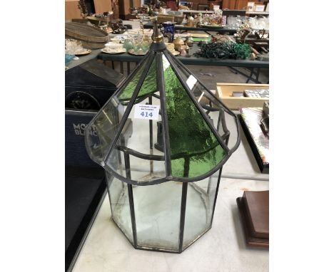 A DECORATIVE GARDEN LANTERN WITH GREEN GLASS PANELS 
