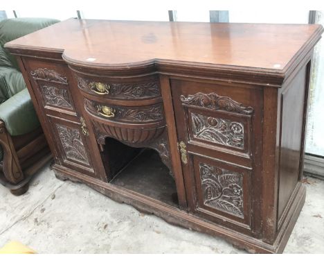 A MAHOGANY BOW FRONT SIDEBOARD WITH TWO DOORS AND TWO DRAWERS HAVING CARVED FRONTS AND BRASS HANDLES 