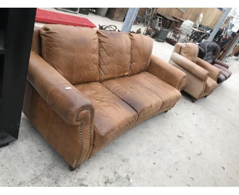 A TAN LEATHER THREE SEATER SOFA WITH MATCHING ARMCHAIR AND FOOTSTOOL 