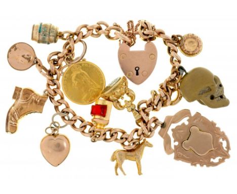 A 9CT GOLD CHARM BRACELET with a collection of charms including a half sovereign and a Victorian  lava skull, 41.5g++Light we