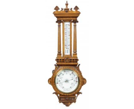 A LATE VICTORIAN CARVED OAK ANEROID BAROMETER, C1900  the mercury thermometer flanked by fluted pillars with ionic capitals, 