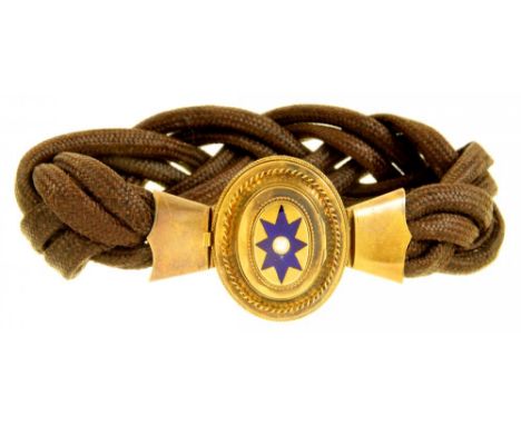 A VICTORIAN PLAITED HAIR MOURNING BRACELET WITH OVAL GOLD AND ENAMEL SLIDE, C1860  the slide with locket back inset hair and 