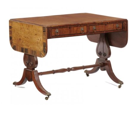 A GEORGE IV SATINWOOD SOFA TABLE   crossbanded in calamander, fitted with drawers and opposing blind drawers, on lyre shaped 