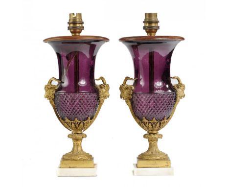A PAIR OF ORMOLU MOUNTED AMETHYST GLASS VASES, EARLY 20TH C  of campana shape with ram's head handles, on square foot and mar