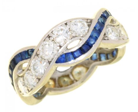 A SAPPHIRE AND DIAMOND TWIST RING  with calibre cut sapphires, in platinum, 6.5g, size M½++Complete but sapphires abraded and