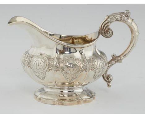 A WILLIAM IV SILVER CREAM JUG of melon form and chased with scallop shells, 11cm h, by John, Henry &amp; Charles Lias, London