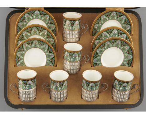 A SET OF SIX WEDGWOOD COFFEE CUPS AND SAUCERS, C1925 with pierced silver cup holders, saucer 12cm diam, printed mark, pattern