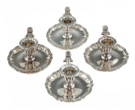 A SET OF FOUR VICTORIAN SILVER CHAMBERSTICKS  with fluted sconce and shaped pan, nozzle and extinguisher, crested, pan 13.5cm