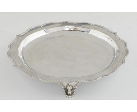 AN ARTS &amp; CRAFTS SILVER WAITER BY THE GUILD OF HANDICRAFT with beaded rim and feet, 20.5cm diam, mark of The Guild of Han