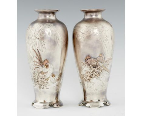 A PAIR OF JAPANESE SILVER AND MIXED METALS VASES, MEIJI PERIOD  finely carved and applied with cock and hen or two pheasants 