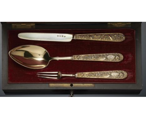 A GEORGE IV COMPOSED SILVER GILT CHRISTENING SET OF SPOON, FORK AND KNIFE   with flower and shell embossed hafts, knife 15.4c