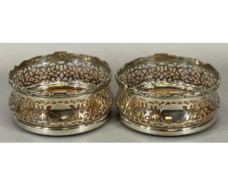 GOOD PAIR OF SILVER PLATED WINE BOTTLE COASTERS, late 19th century with shaped and detailed upper rims, pierced bodies and ci