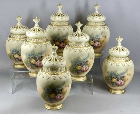 SEVEN ROYAL WORCESTER STYLE CREAM GLAZED POT POURRI of baluster form, bodies decorated with floral sprays, covers pierced and