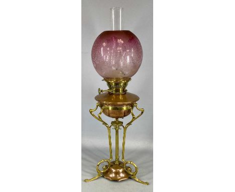 ARTS & CRAFTS BRASS AND COPPER OIL LAMP with open framework, Hinks burner, globular etched pink glass shade, 62cms (h) exclud