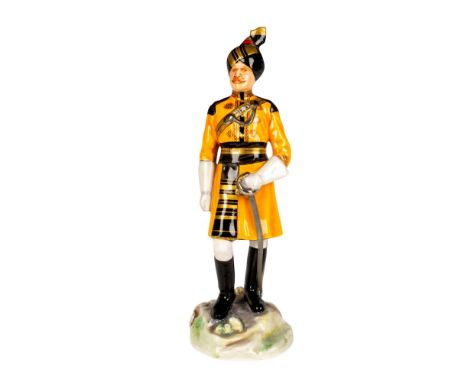 Handmade and hand painted figure of an officer from the Indian Army holding a metal sword. Black and orange coloration. Micha