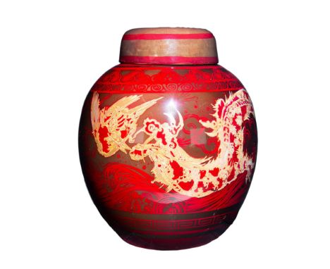 A stunning Ginger Jar and Cover decorated in a High flambe glaze, adorned with a dragon chasing a phoenix in gilt luster. Inc