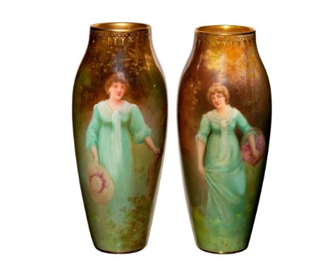 Hand painted ceramic vases features woman in a meadow; soft pastel green and brown coloration. Ovoid form; gilded rim. Signed