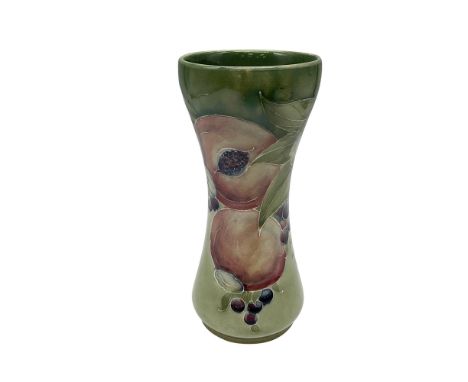 Lovely pomegranate design over light green ochre background. Vase is slightly curved at rim. Moorcroft signature. Artist: Wil