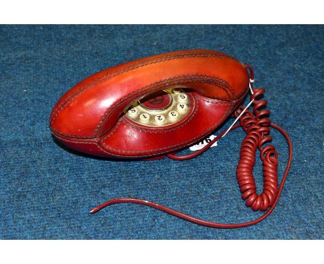A LEATHER COVERED GENIE PUSH BUTTON TELEPHONE, appears complete, used condition, marking and wear to leather, not converted f