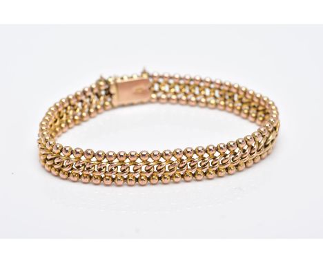 A YELLOW METAL LINE BRACELET, of a curb link and ball design, fitted with a push pin integrated box clasp, stamped '9ct', len