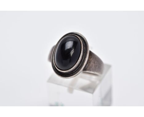 A GEORG JENSON ONYX RING, designed with a central oval onyx cabochon within a collet mount, plain polished band, signed 'Geor